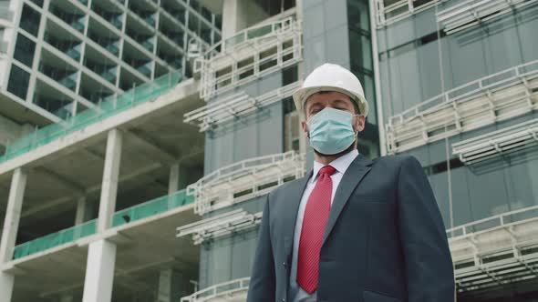 Close Up Portrait Senior Engineer Wearing a White Safety Helmet with a Beard a Business Suit and a alt