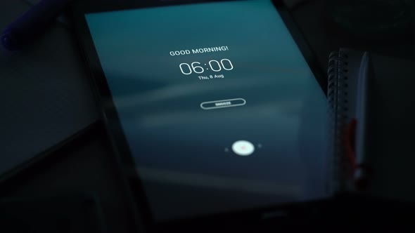 Good Morning Alarm Clock on the Tab on the Desktop in the Dark Room , Close-up