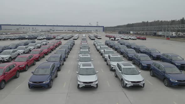 The New Cars are Lined Up in the Parking Lot Outside the Production Facility