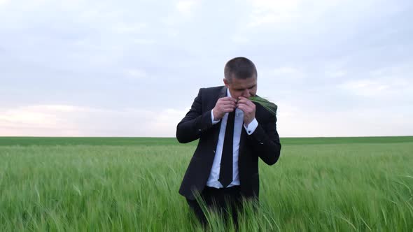 Young Farmer Business Owner Inspects a Wheat Field alt