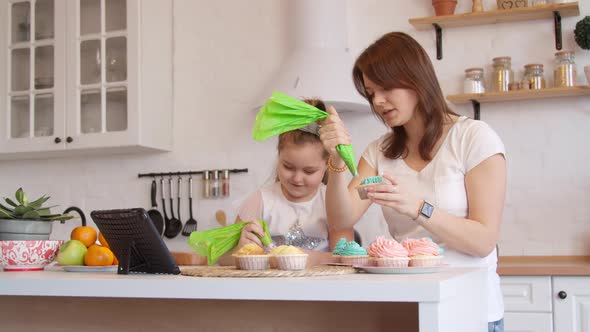 Mother and Daughter Icing Cupcakes