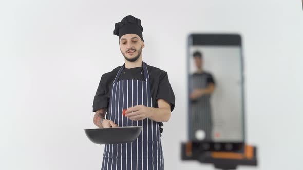 Professional Male Chef Doing Online Cooking Lesson Filming Him with Smartphone alt