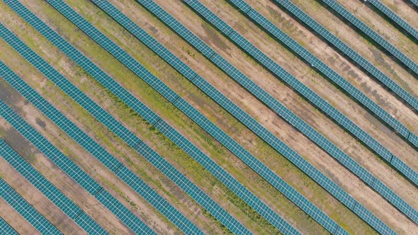 Aerial Top View on Solar Power Station in Green Field on Sunny Day. Solar Farm alt