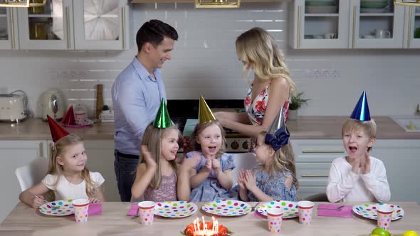 Happy Family of Five Children Dad and Mom Celebrate Their Daughter's Birthday in the Kitchen