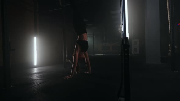 Slender Sporty Woman is Walking on Hands in Fitness Hall Training Balance Vestibular System alt