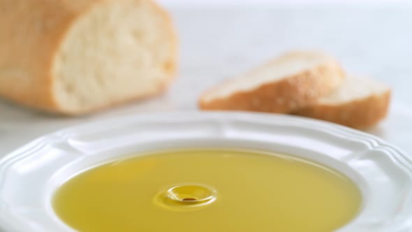 Balsamic vinegar dripping into olive oil. Slow Motion. alt