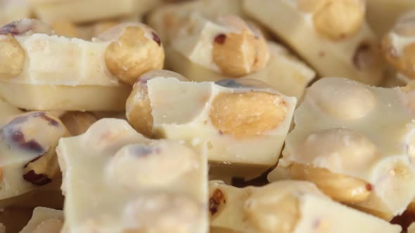White chocolate with nuts close up. Sliding shot. 4K UHD video alt