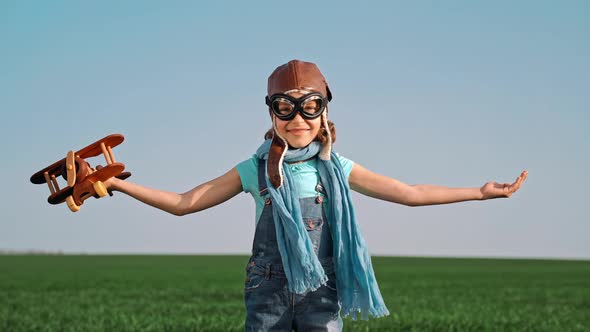 Happy Child Playing with Toy Airplane against Summer Sky Background