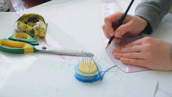 The Fashion Designer is Developing the Design of a New Dress