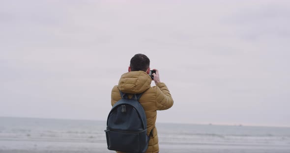 Young Guy Tourist Arrived on the Large Beach with alt