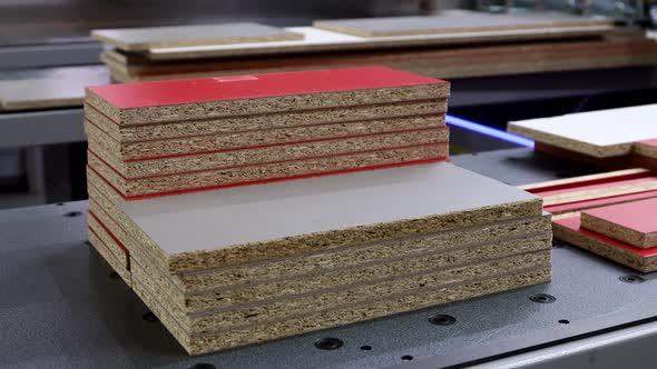 Particle Boards are Stacked on a Woodcutting Machine