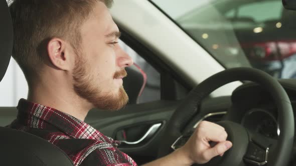 Close Up of a Happy Handsome Male Car Ownes Smiling with Car Keys in His Hand alt