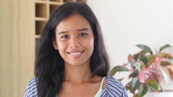Portrait Beautiful Young Filipina Woman Smiling at the Camera with Happy Emotion alt