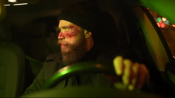 Hipster man with beard and cinema makeup driving a car alt