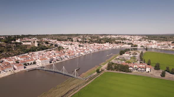 River Sado and cityscape of beautiful town Alcacer Do Sal in Portugal, aerial view alt