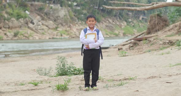 Boy Holding A Book And Smiling alt