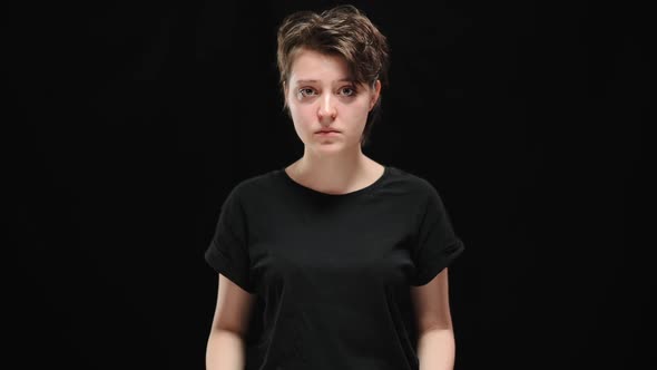 Desperate Woman Raising Sign with Me Too Hashtag Looking at Camera with Desperate Facial Expression alt