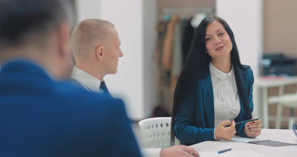 Beautiful Young Business Woman Talking with a Partner and Smiling Laughing alt
