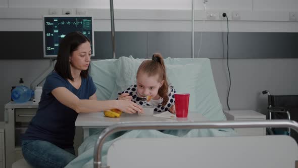 Mother Standing with Sick Girl While Eating Healthy Food Meal During Lunch Waiting for Medical alt
