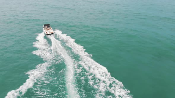 Holidaymakers Riding Motorboats at Poniente Beach on the Costa Blanca in Spain alt