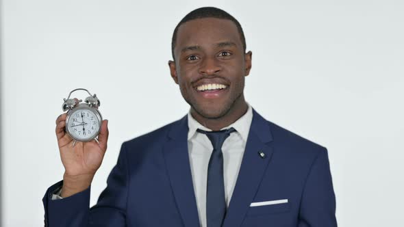 African Businessman Holding a Clock, White Background  alt