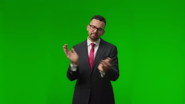 Happy Young Businessman Standing and Applauding on a Green Screen alt