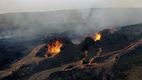 Slow motion aerial view of smoke over active, hot and continuous volcanic eruption with fresh flowin alt
