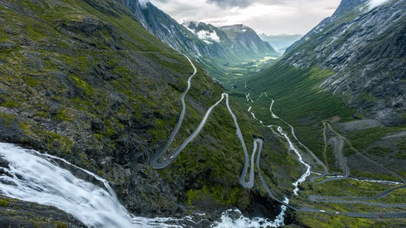 Vehicles Driving On Notable Winding Road Of Trollstigen From Trolls Path Viewpoint With Stigfossen W alt