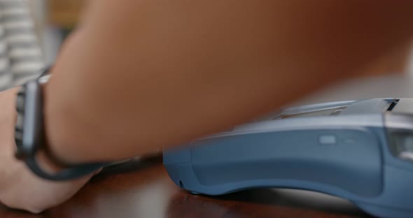 Woman buy a cup of coffee with credit card payment on pos terminal alt