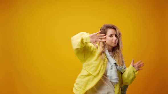 Woman Professional Dancer Dancing in Studio Against Yellow Background alt