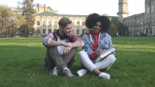 Students Couple Preparing For Exam Together At College Campus