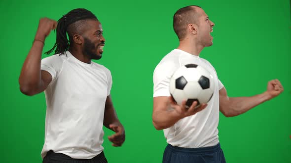 Inspired Satisfied African American and Caucasian Men Cheering at Green Screen Looking Around alt
