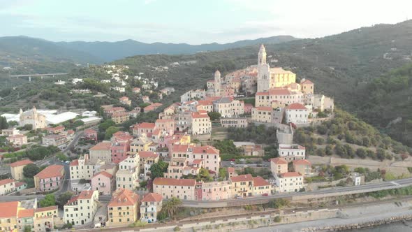 Aerial: flying around Cervo medieval town on the mediterranean coast, Liguria riviera, Italy alt