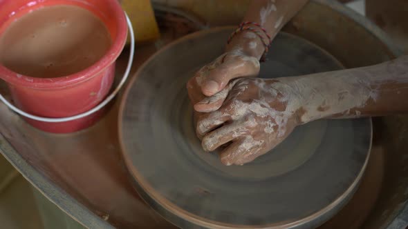 Slowmotion Closeup Shot of a Teacher Potter Teaching His Apprentice How To Make a Clay Bowl alt