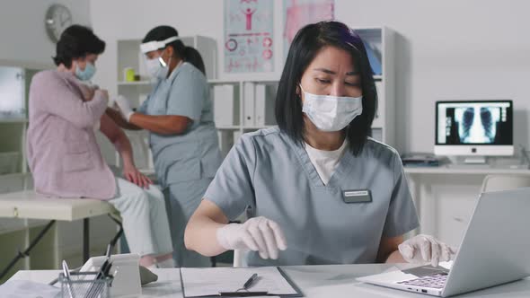 Female Doctor Working On Laptop alt