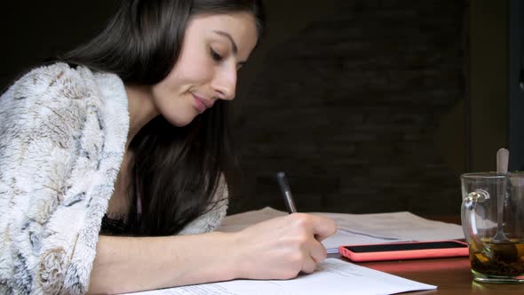 Young Woman Reading Theory and Preparing for Lectures alt