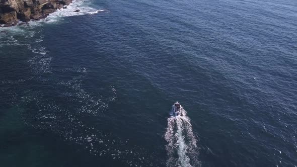Top down overhead flyover a single speed fishing boat on the ocean at Sydney Coastal waters alt