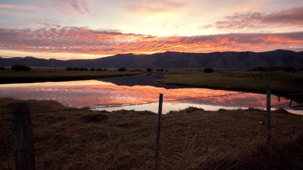 Sunrise time lapse reflecting in the Salt River in the Wyoming landscape alt