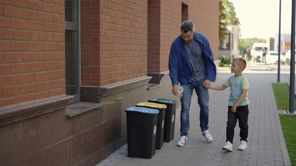 Dad Teaches His Son to Properly Sort Garbage alt