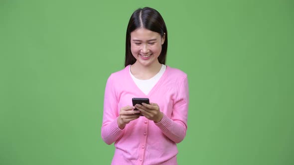 Young Beautiful Asian Woman Using Phone