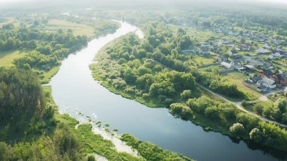 Russia. Aerial View Of Summer River Landscape And Small Village In Sunny Summer Evening. Top View Of alt