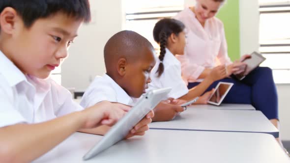 School Kids and Teacher Using Digital Tablet in Classroom alt