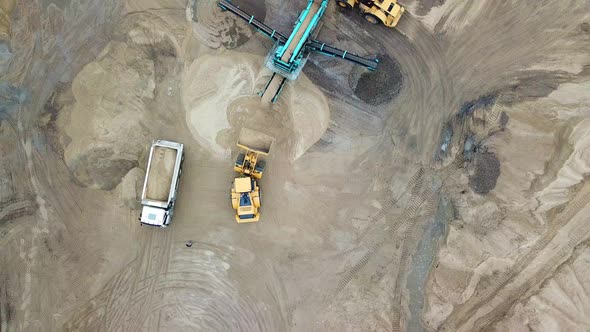 Sand mining industry. Bulldozer machine. Crawler bulldozering at sand mine. Mining machinery working alt