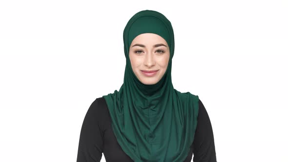 Portrait of Satisfied Religious Woman in Traditional Arabic Scarf Nodding and Meaning Approval or alt