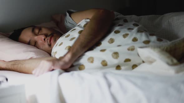 Close up of the Asian man sleeping in the bedroom at home.