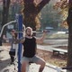 Strong Fit Couple Doing Pull Ups Together in an Awesome Outdoor Gym - VideoHive Item for Sale