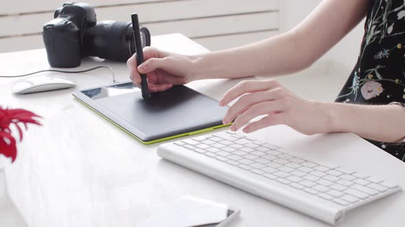 Concept of Freelancing or Office Work. Young Female Photographer, Retoucher or Graphic Designer with alt