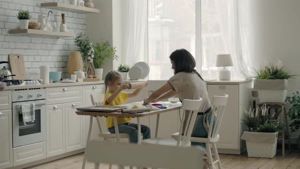 Family Mom and Daughter Are Cooking in the Kitchen