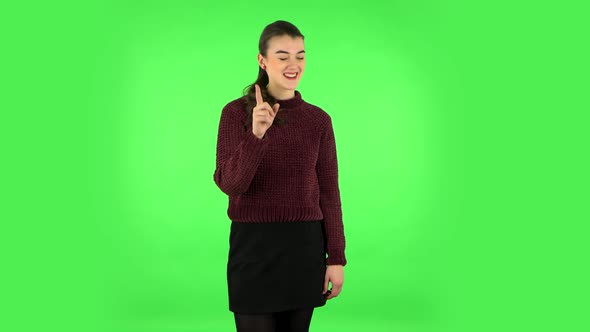 Girl Listens Carefully, Threatens with a Finger Seductively. Green Screen alt