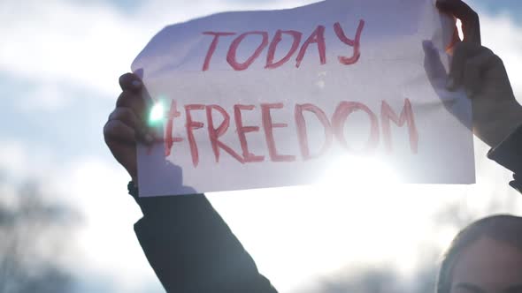 Freedom Today Placard in Sunrays Outdoors in Female Caucasian Hands alt